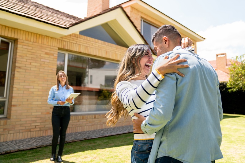 happy-couple-buying-a-house-and-celebrating-after-getting-the-keys