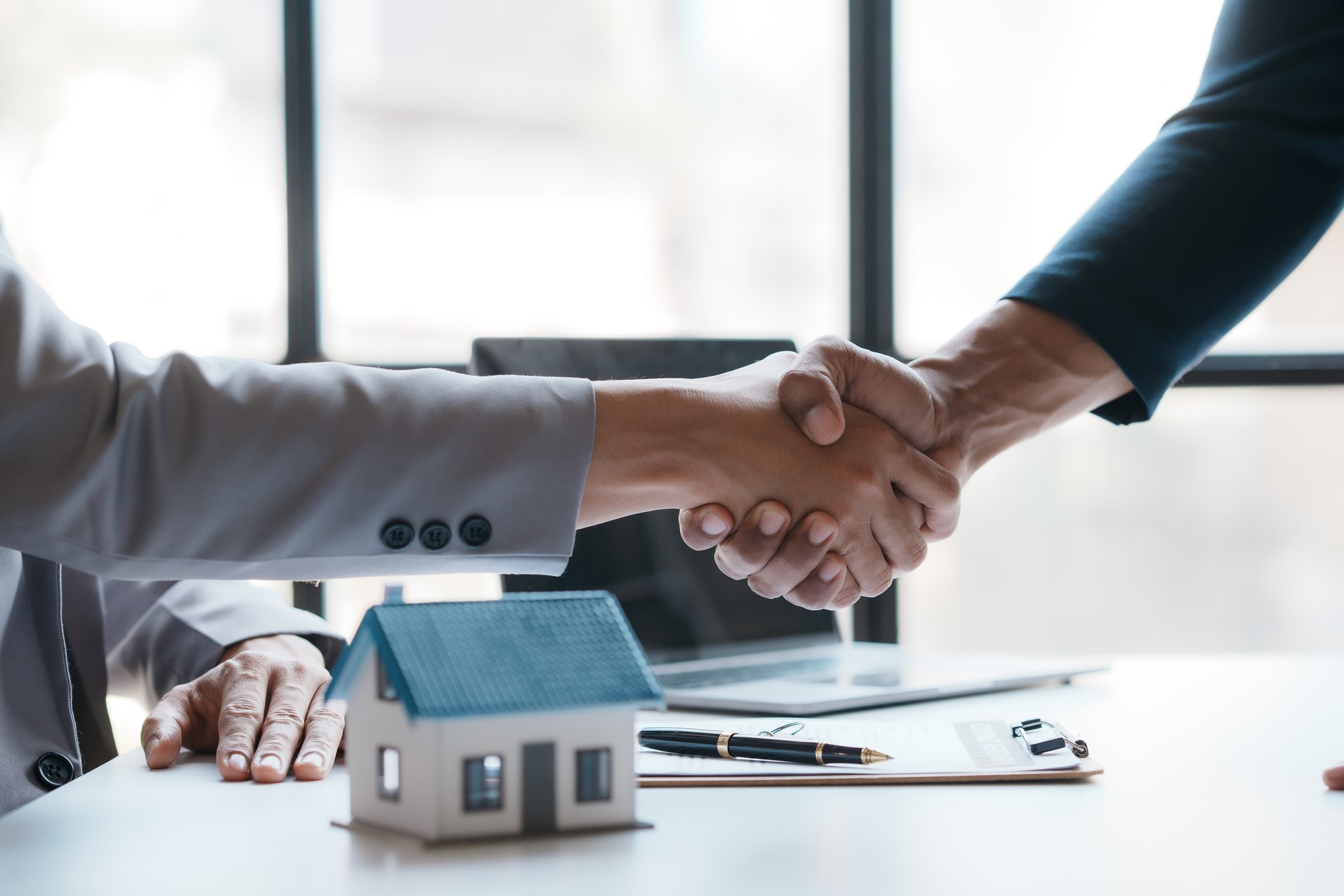 Real estate agent shakes hands